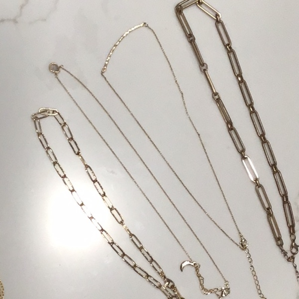 Four gold tone necklaces